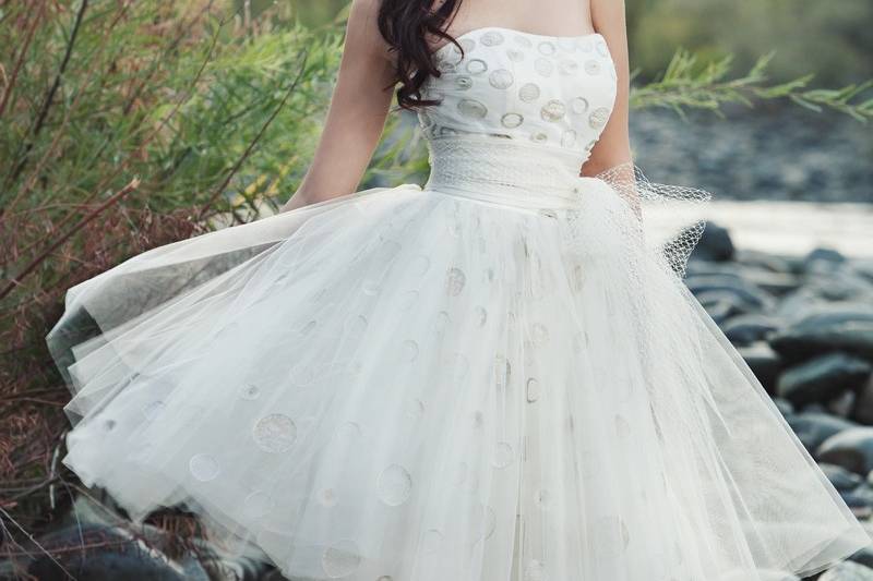 Spring 2014 - AprilKnee-length strapless gown with built-in corset featuring hand-embroidered polka dot tulle.  Includes sash with exaggerated bow made from Russian tulle.