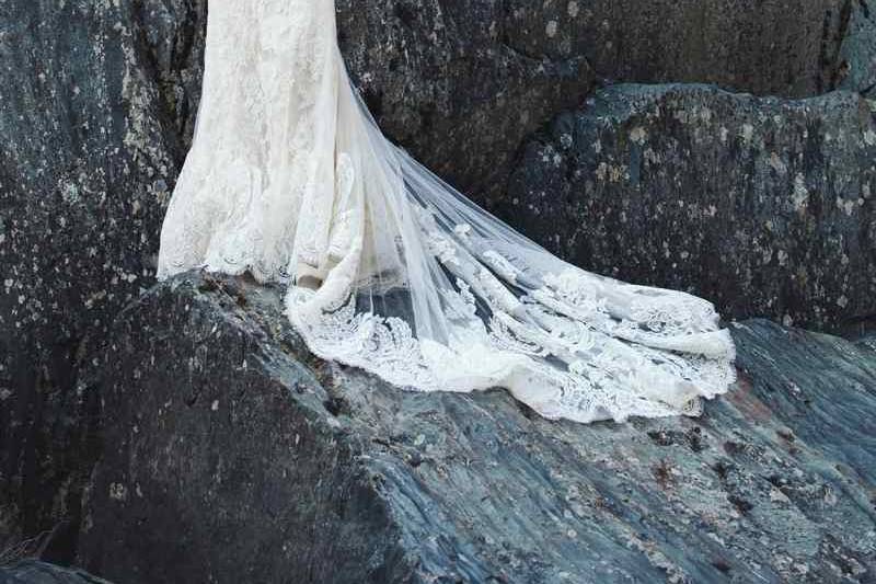 Spring 2014 Aurora Mermaid gown of buttercup silk shantung and a re-embroidered French Alençon lace. Sheer mermaid overlay with a re-embroidered French Alençon lace asymmetric applique over an exposed back and climbing up the train.