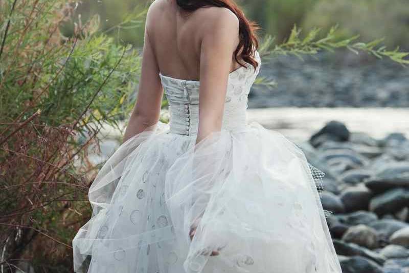 Spring 2014 - AprilKnee-length strapless gown with built-in corset featuring hand-embroidered polka dot tulle.  Includes sash with exaggerated bow made from Russian tulle.