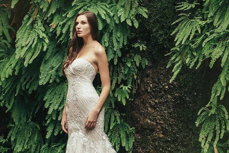 BreanneStrapless sweetheart gown made from layers of lightweight fabrics. Blush and ivory organza is the base for an Ivory Chantilly lace allover. Soft blush tulle ruching on the bodice and layers on the skirt is topped by a floral Italian embroidery.