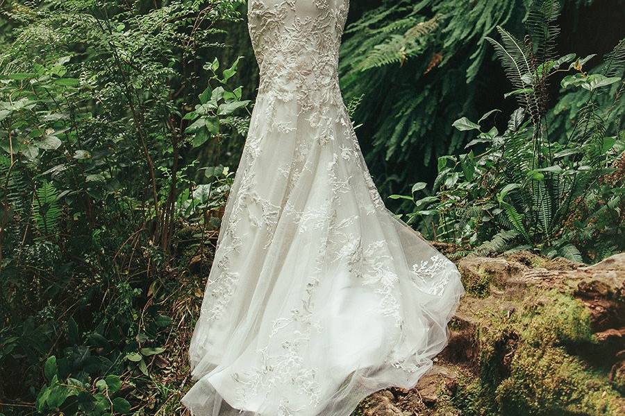 BriarStrapless ivory silk crepe gown with a minimal mermaid silhouette. A Swarovski crystal belt on a thin Mokuba ribbon defines the waist with Italian embroidery on tulle throughout the bodice and the sheer skirt overlay.