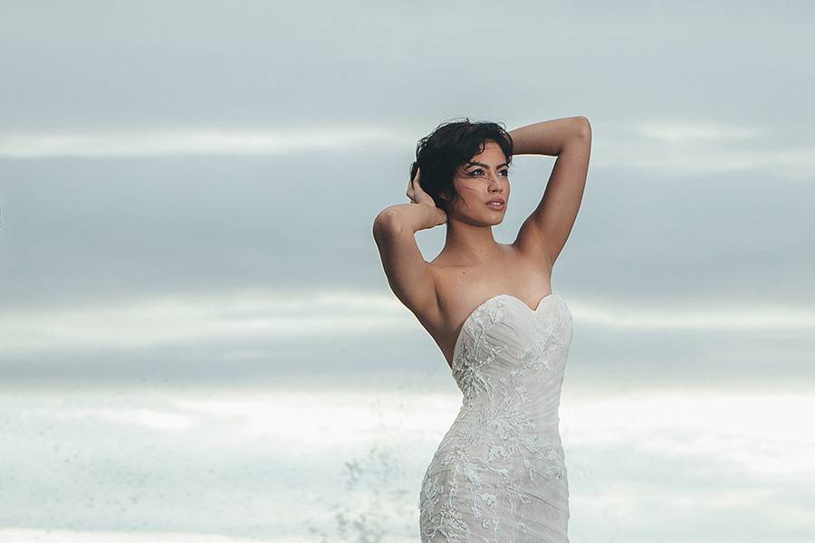 BerkeleySweetheart strapless mermaid gown with a dramatic full skirt and airy bubble hem. Blush tulle is ruched over a light Ivory French Chantilly lace underlay. Italian embroidery appliqué draws attention to the small waist created by a sheer organza corset inside.