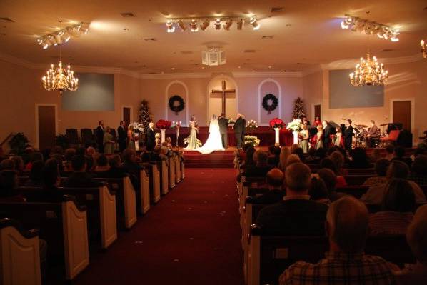Bride and Groom at front of church with wedding party.