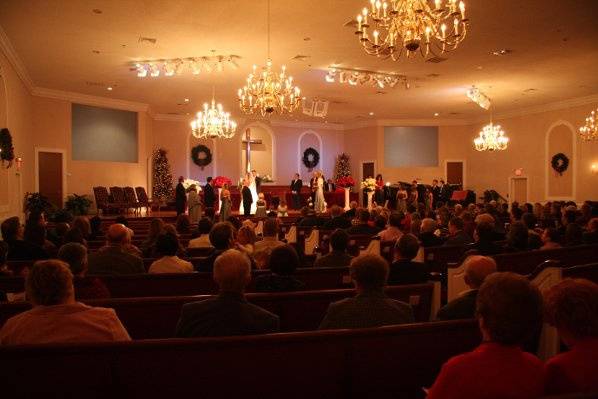 Full view off church and wedding party.