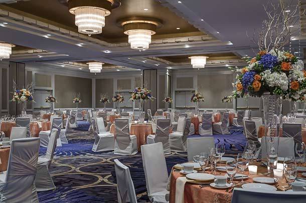 Our brand new ballroom features a neutral balance of cool colors and soft lighting so your event can be the star.  Hand blown scones created by a local artist adorn the walls.