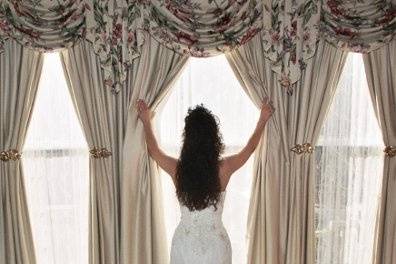 Bride looking out window for groom