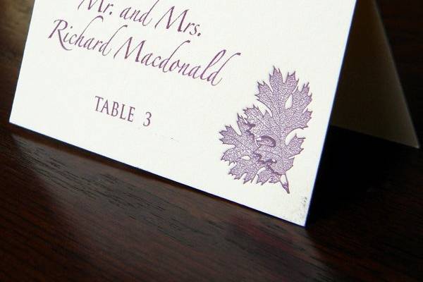 Eggplant ink. Leaf design letterpress escort card with digital calligraphy.