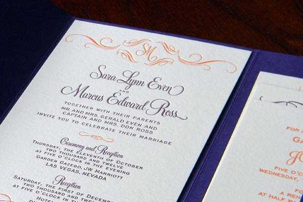 Letterpress printed tangerine and eggplant wedding invitation mounted to eggplant pocket.