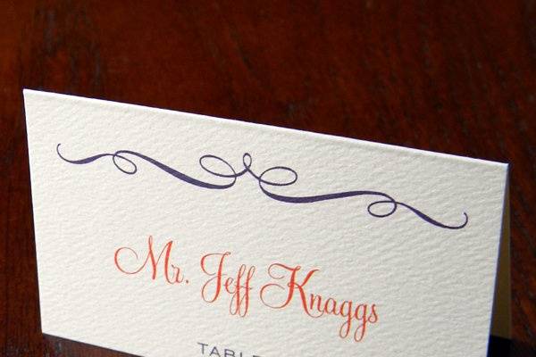 Eggplant and tangerine inks. Escort card with digital calligraphy.
