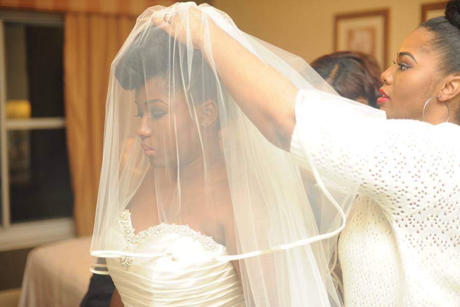 Assisting the bride with her veil