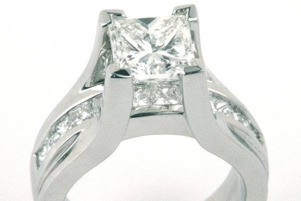 Princess Cut Diamond in Platinum Floating Setting with Princess Cut Diamonds flowing under center diamond.