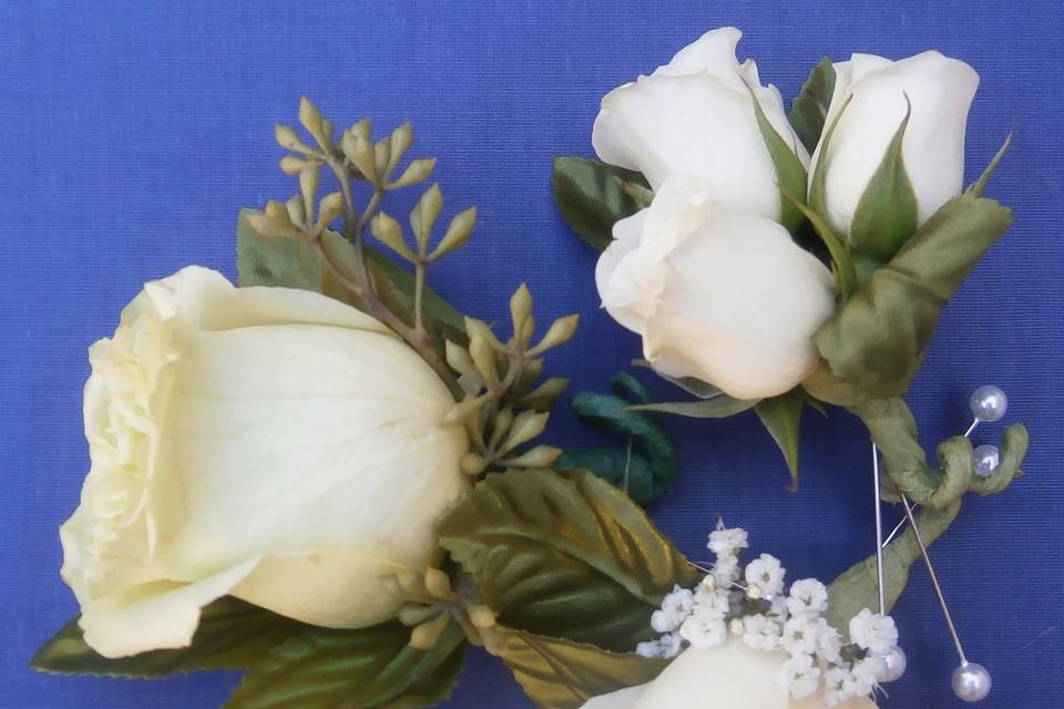 Boutinierres - white roses.