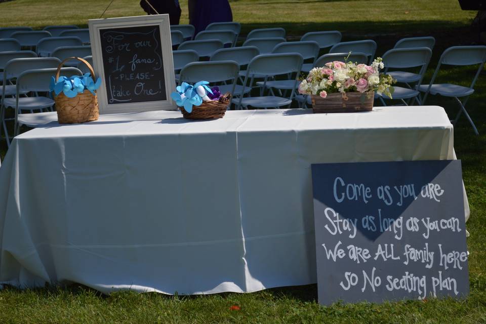 Ceremony table offered battery-operated fans to help keep guests cool in the 100 degree heat.