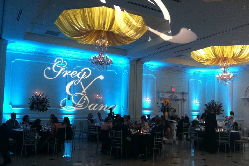 Blue uplights and monogram projection