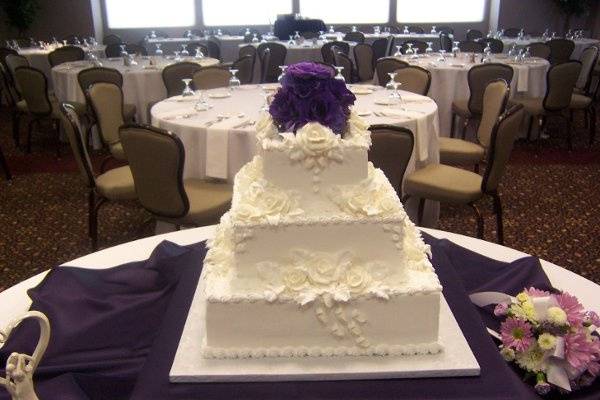 Fresh flowers accent this all white on white design.  A traditional cake that is a classic