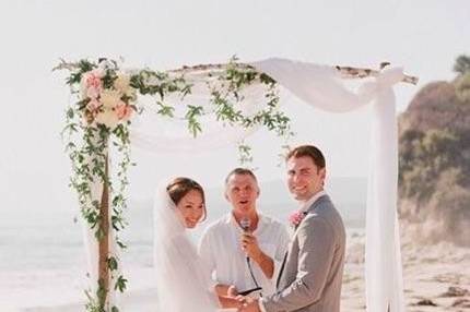 The newlyweds with the wedding officiant