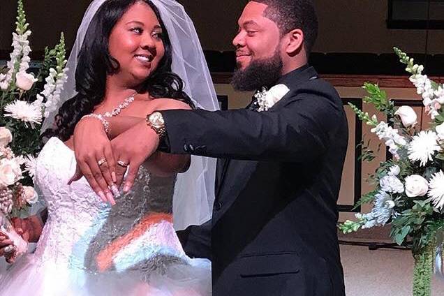 Bride and groom showing rings