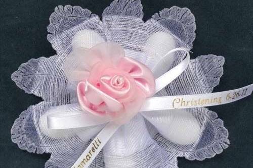 Padua ribbon flower favor with five Jordan almonds, satin rose and personalized ribbon bow. See Confettiflowers.com