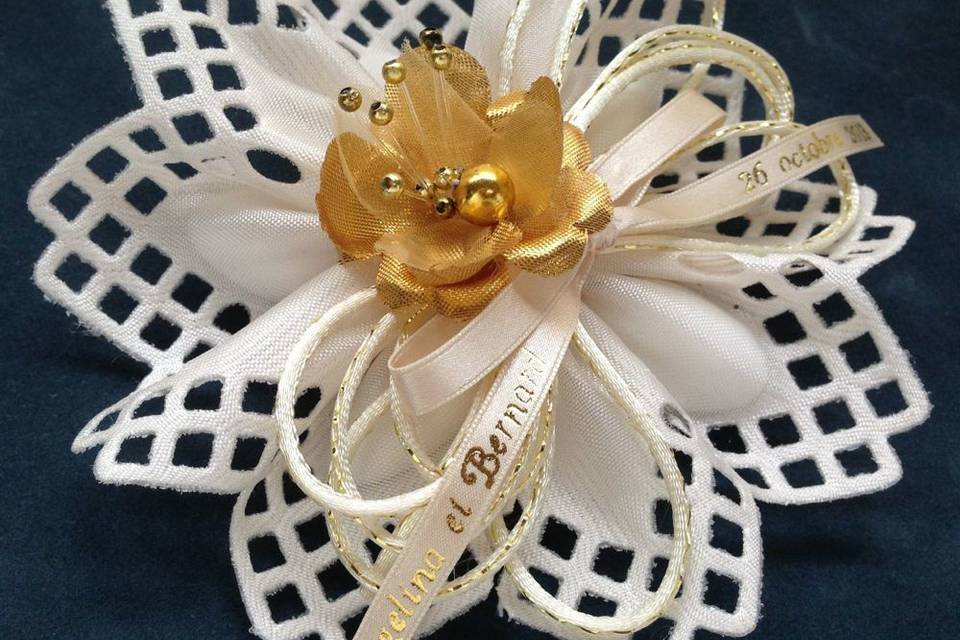 Lucca Italian ribbon flower with gold flower and personalized accents. See Confettiflowers.com