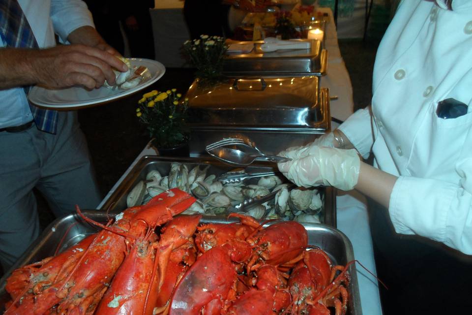 Typical Lobster Bake Wedding Buffet includes green salad, lobster, clams, red potatoes, corn, assorted breads, fruit platter and rsvp non-lobster meals.    (Other options are also available)
