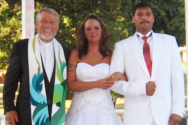 The newlyweds with the officiant