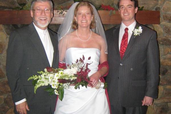 The newlyweds and the officiant