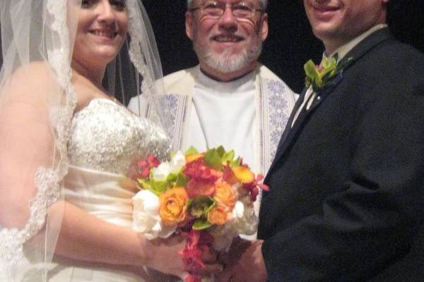 The newlyweds with the officiant