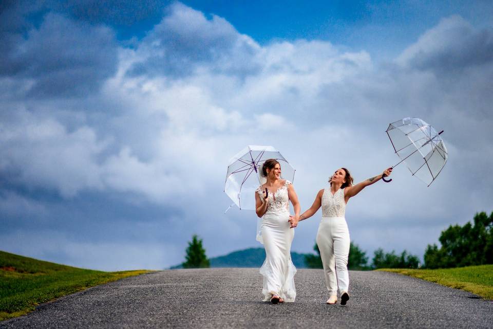 Two brides with clear umbrella