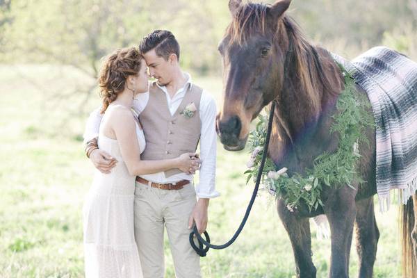 Bride and groom with a horse