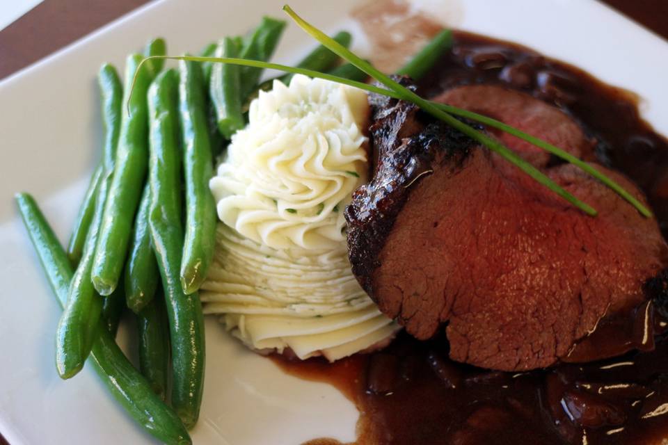 Beef Tenderloin with Red Wine Mushroom Sauce, piped herbed potatoes and crispy green beans.