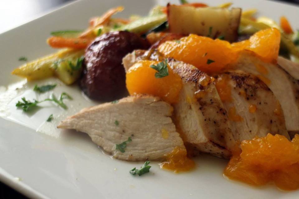 Lemon garlic chicken with a mandarin orange glaze, julienne vegetables and roasted potatoes.