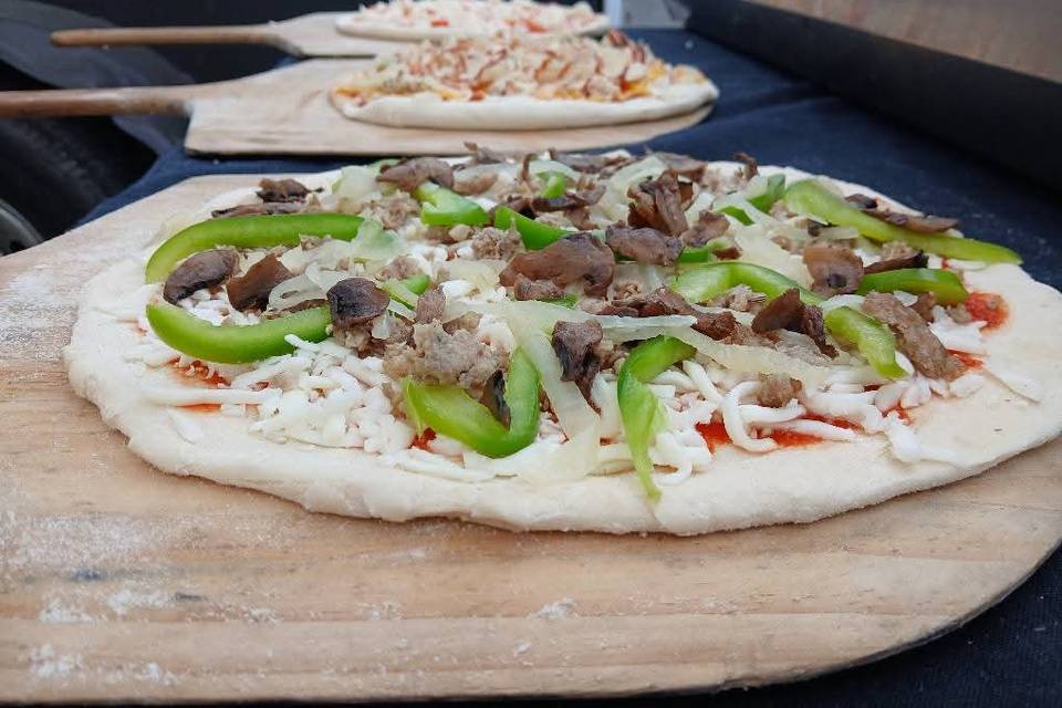 Several freshly topped pizzas