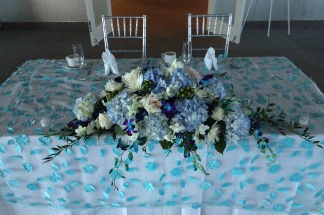 Bride and groom's table for their reception at the Waterstone Resort in Boca Raton, Florida. Floral arrangement by Tropical Elegance.