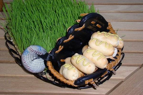 a comfort food updated.  All beef kosher mini hot dogs in pastry blankets served from a catchers mitt in a field of wheatgrass.