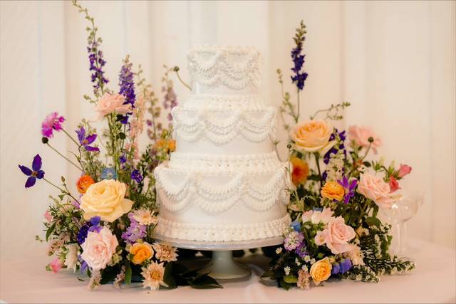 White three tier cake with wildflowers
