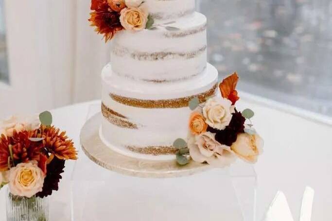 Semi naked three tier cake with fall florals