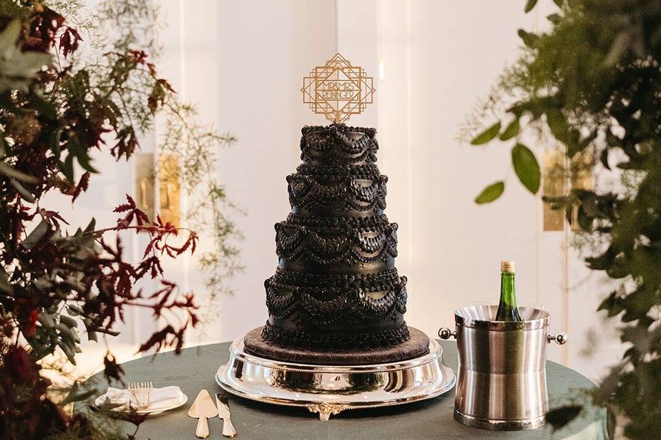 Black four tier vintage piped cake
