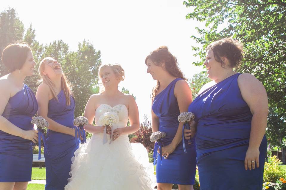 Beautiful antique white, lemon, and pale yellow bouquets for this smiling bridal party.