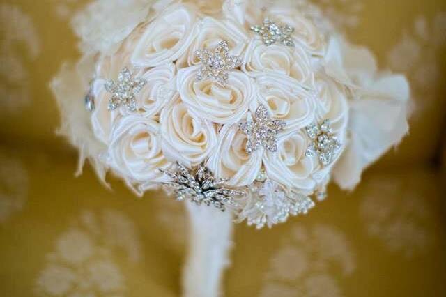 The embellishment on the handle is from the collar of Mom's wedding gown. The collar underneath the roses is from her headpiece.