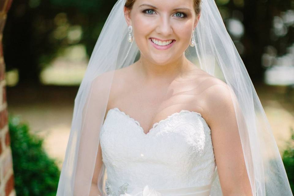 Brooke's bouquet is made in part from her mother's wedding gown. Satin roses and fabric flowers from the lace, satin, and tulle of Mom's gown. Grandmother supplied the brooch