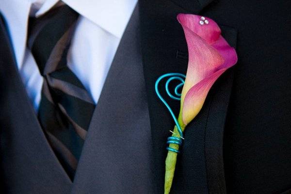 Groom's boutonniere using a fuchsia mini calla and teal wire curls and a little bling on the tip of the calla.