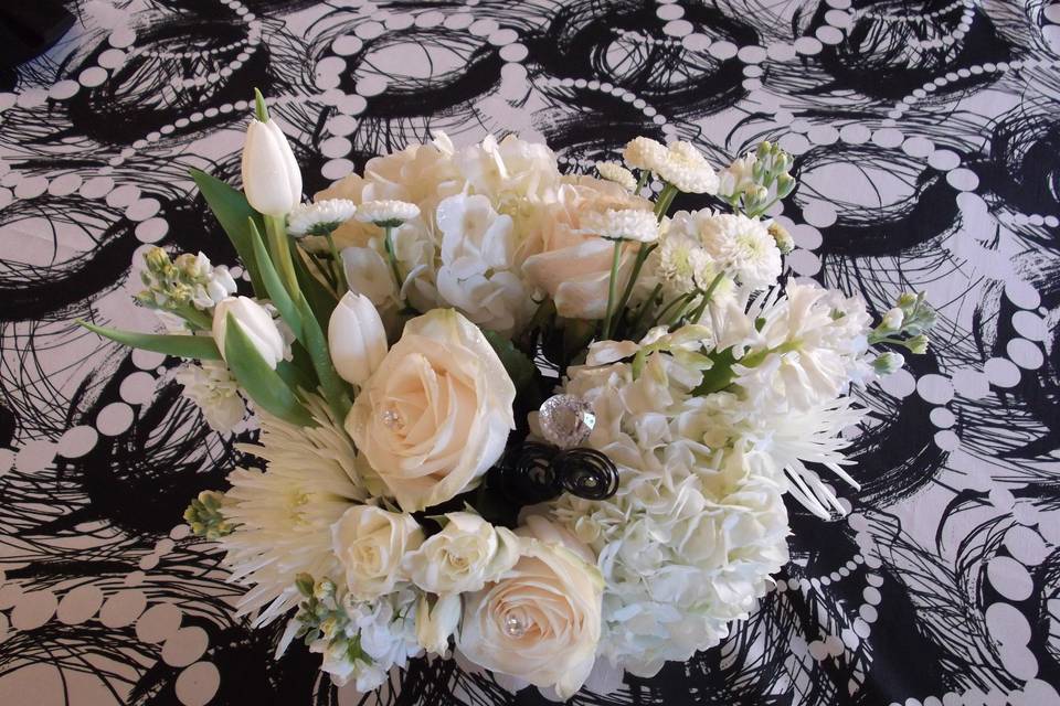 All white centerpiece of tulips. hydrangea, fuji mums, roses