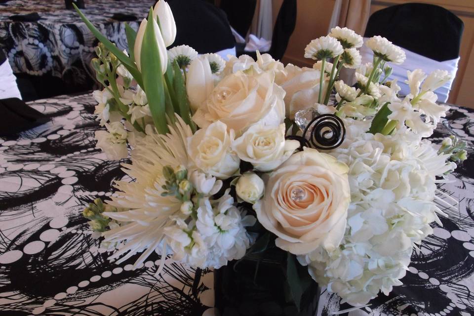 Centerpiece of tulips, roses, hydrangea, spray roses, button mums, fuji mums and wire accents