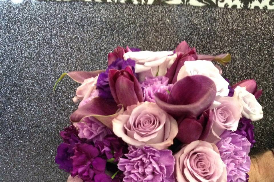 Bridal bouquet of roses, miniature calla lilies, Florigene carnations, lisianthus