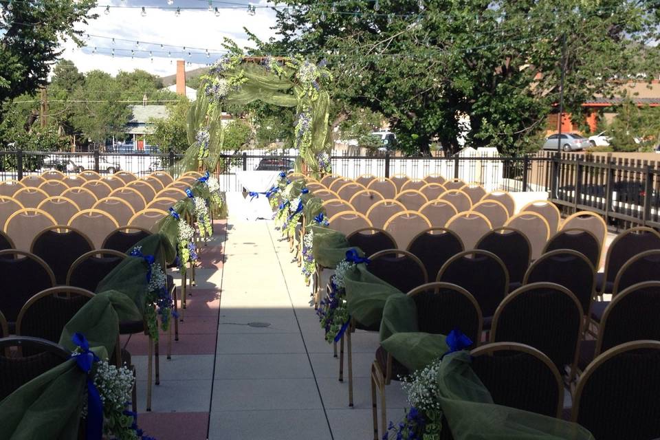 The Hassayampa Inn rooftop. Willow arch set at the front with aisle markers of delphinium and bells of Ireland