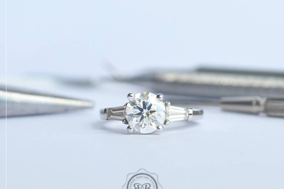 Custom Three-Stone Engagement Ring. Platinum and Round Diamond with tapered baguette side stones