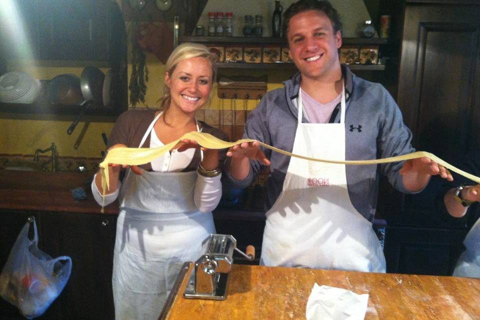 Sam and Ryan learning how to make pasta in Italy.