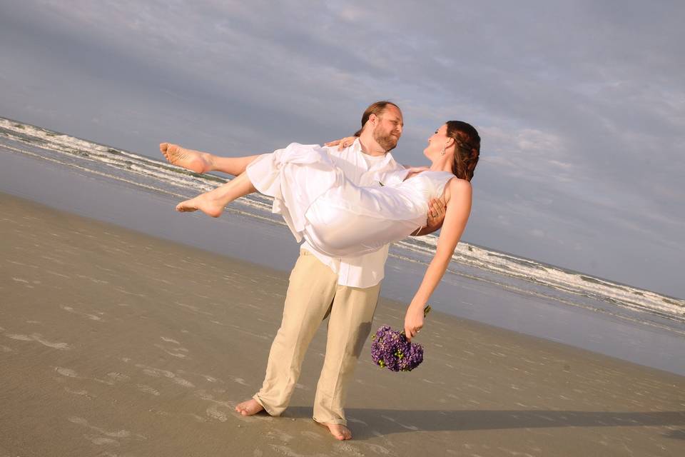 Groom lifting his bride