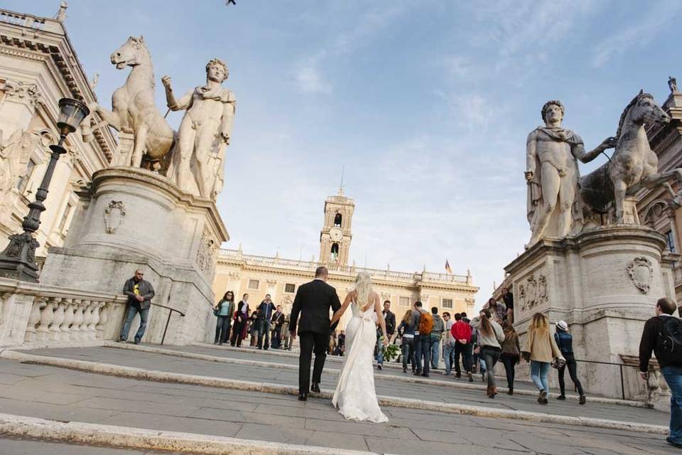 bride and groom reach the top of the Piazza del Campidoglio in the very center of Rome
