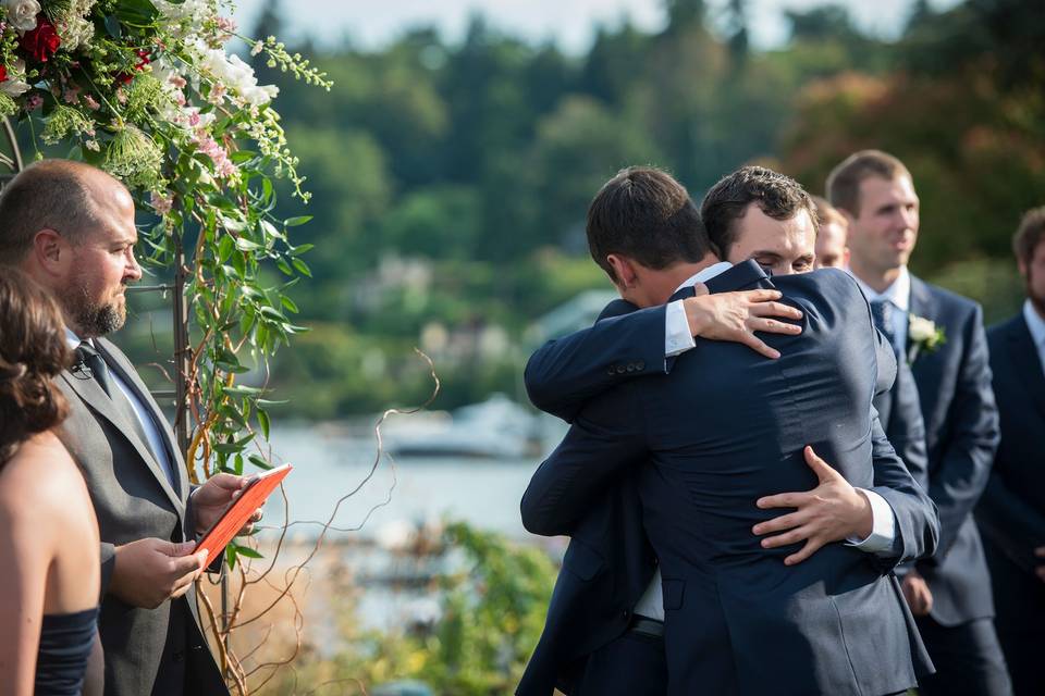 Groomsmen hugging groom